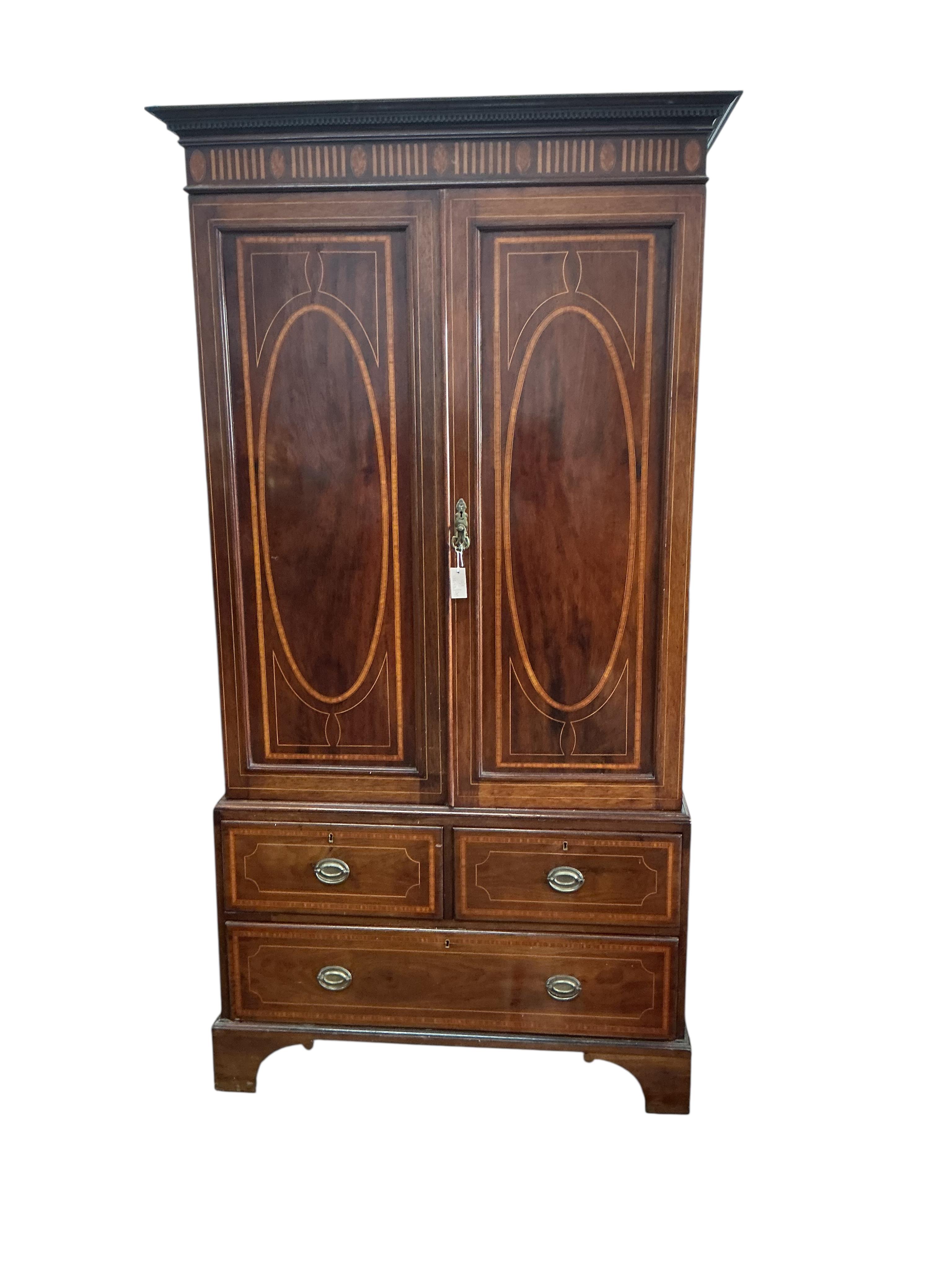 An Edwardian satinwood banded mahogany linen press, width 122cm, depth 58cm, height 230cm